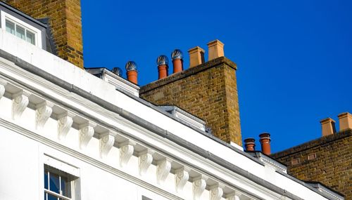 Low angle view of built structure against blue sky