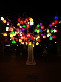 Illuminated street lights in city at night