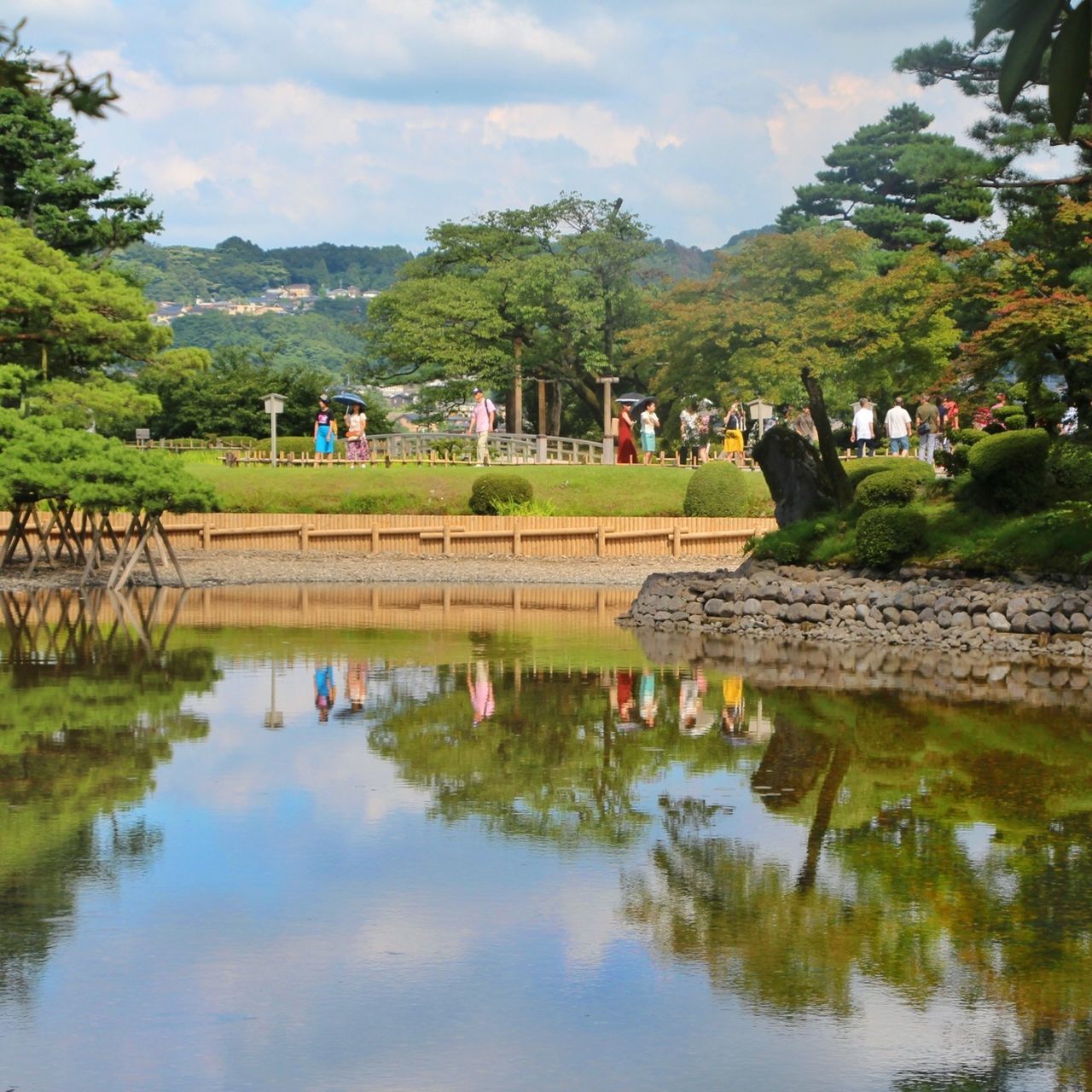 tree, water, reflection, sky, architecture, built structure, lake, pond, building exterior, cloud - sky, waterfront, river, cloud, nature, tranquility, day, tranquil scene, standing water, beauty in nature