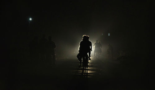 Silhouette man on illuminated lights