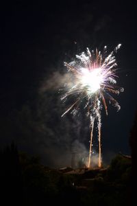 Low angle view of firework display at night