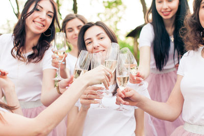 Happy young woman drinking glasses