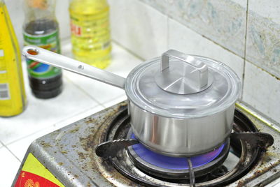 Close-up of cooking utensil on stove in kitchen at home