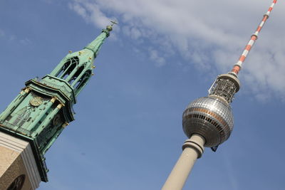 Low angle view of fernsehturm and church against sky