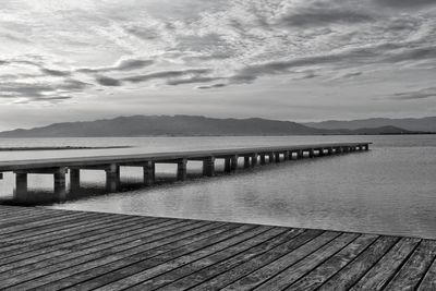 Pier over lake against sky