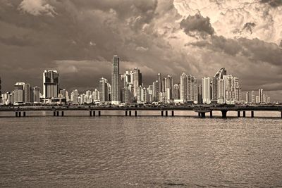 Pier over sea against buildings in city