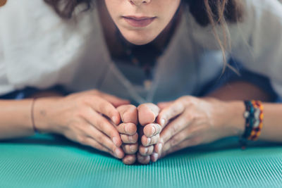 Close-up of woman sitting on table