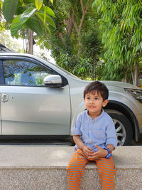 Portrait of cute boy sitting in car