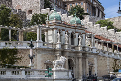 Entrance of  castle garden bazaar in budapest, hungary, europe. statues, ornaments, turquoise domes.