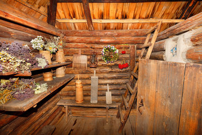 The utility room and the entrance hall of  old rural hut are filled with various household utensils