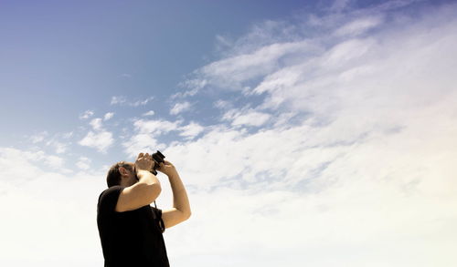 Silhouette of woman standing against sky