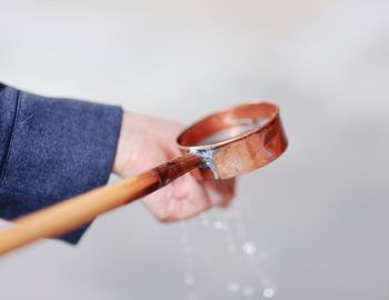 Close-up of hand holding ladle