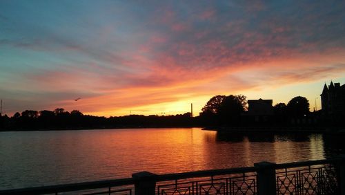 Scenic view of lake against orange sky