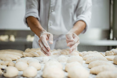 Midsection of man preparing food