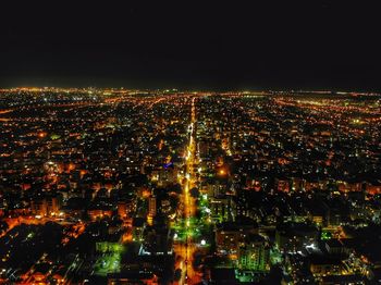 High angle view of illuminated city buildings at night