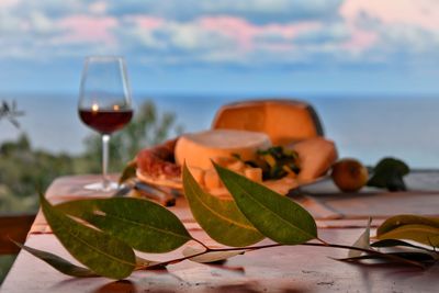 Close-up of drink and cheese on table