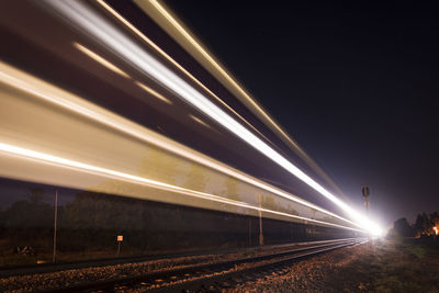 Light trails on railroad track at night