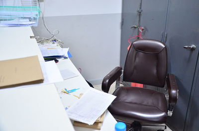 Empty chair by desk at office