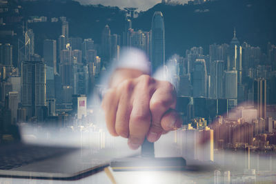 Digital composite image of man and woman against buildings in city