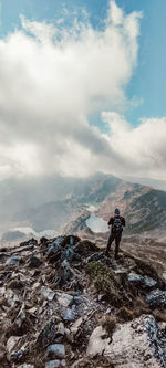 Man standing on rock looking at landscape