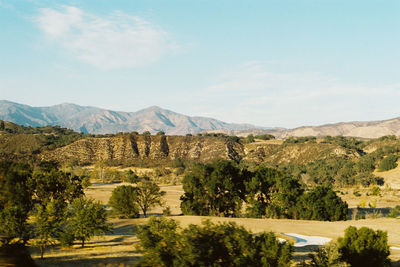 Scenic view of mountains against cloudy sky