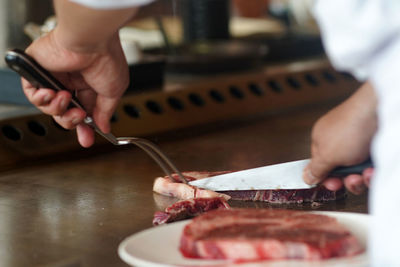 Midsection of man preparing food