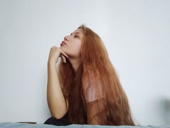 Woman with long hair sitting at home