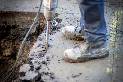 Low section of man working on puddle