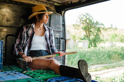 Woman looking away while sitting in truck