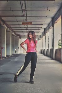 Full length of woman standing in corridor