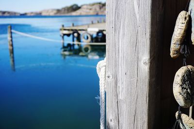 Close-up of wooden post against sea