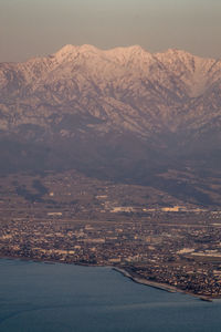 Scenic view of snowcapped mountains against sky during sunset