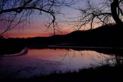 Scenic view of lake against orange sky