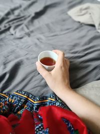 High angle view of woman holding coffee cup