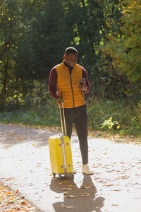 Rear view of man standing in forest