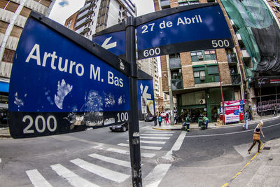 Fish-eye view of road signs by city street