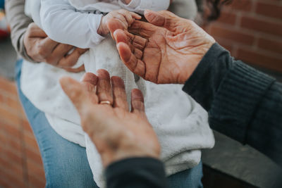 Midsection of couple holding hands