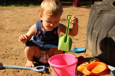 High angle view of girl playing with toys at beach