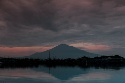 Scenic view of lake against sky at sunset