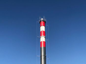 Low angle view of lighthouse against blue sky