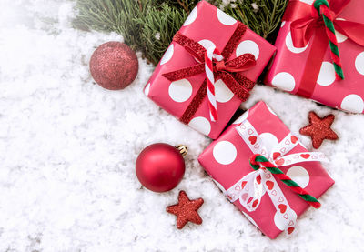 High angle view of christmas decoration and gifts on snow