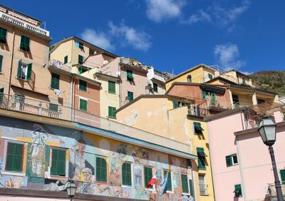 Low angle view of buildings in town against sky