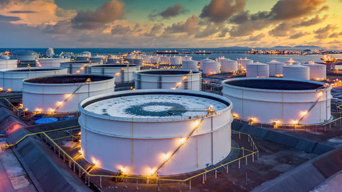 Storage of chemical products like oil, petrol, gas, aerial view oil storage tank terminal and tanker