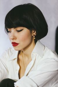 Close-up of young woman wearing red lipstick at home