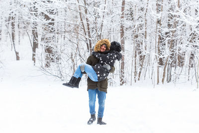 Woman standing on snow covered land