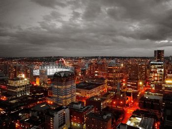 Aerial view of illuminated cityscape against sky