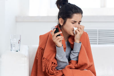 Sick woman sitting at home