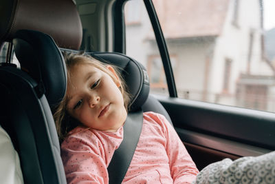 Portrait of smiling boy sitting in car