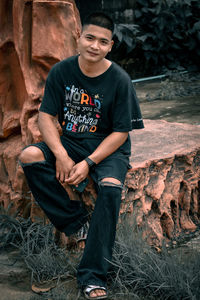 Portrait of man standing on rock