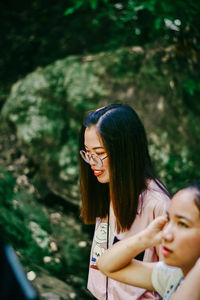 Portrait of woman with arms raised